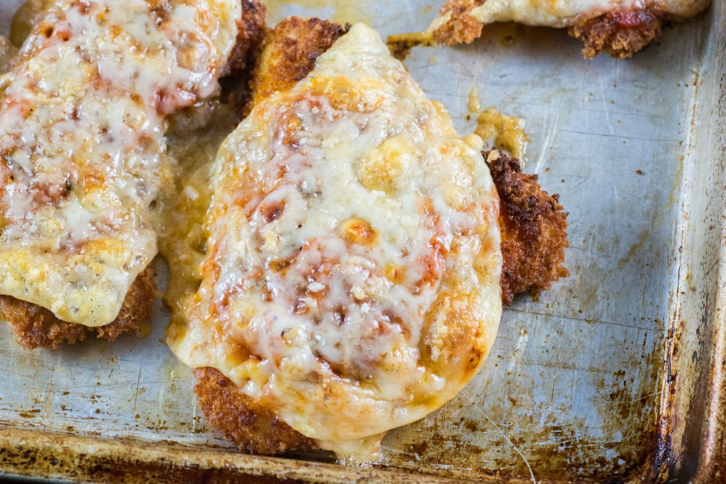 Turkey Cutlets Parmesan on a baking sheet