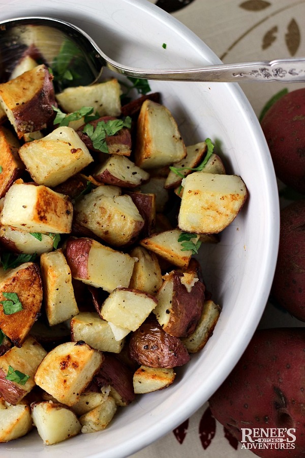 Garlic roasted potatoes in a white serving dish