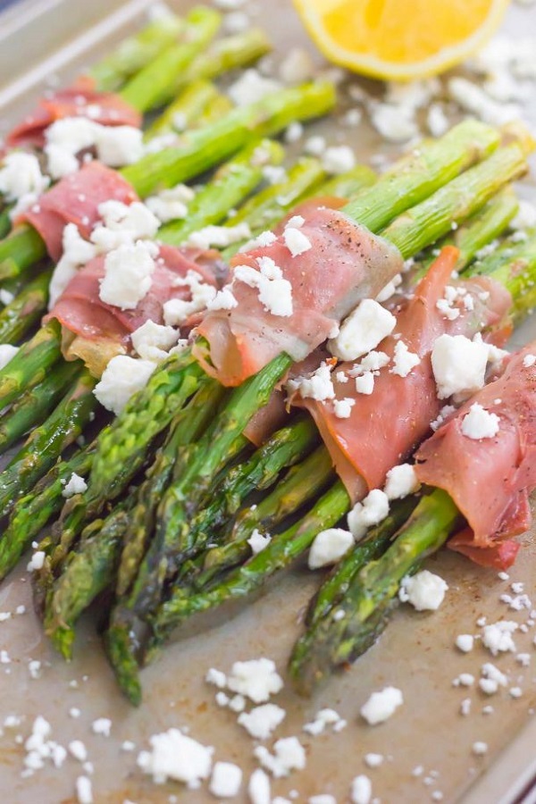 Prosciutto wrapped asparagus with feta in a cooking tray