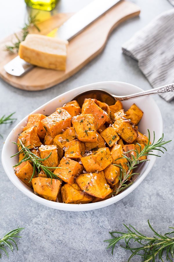 Rosemary Parmesan sweet potatoes in a white serving dish