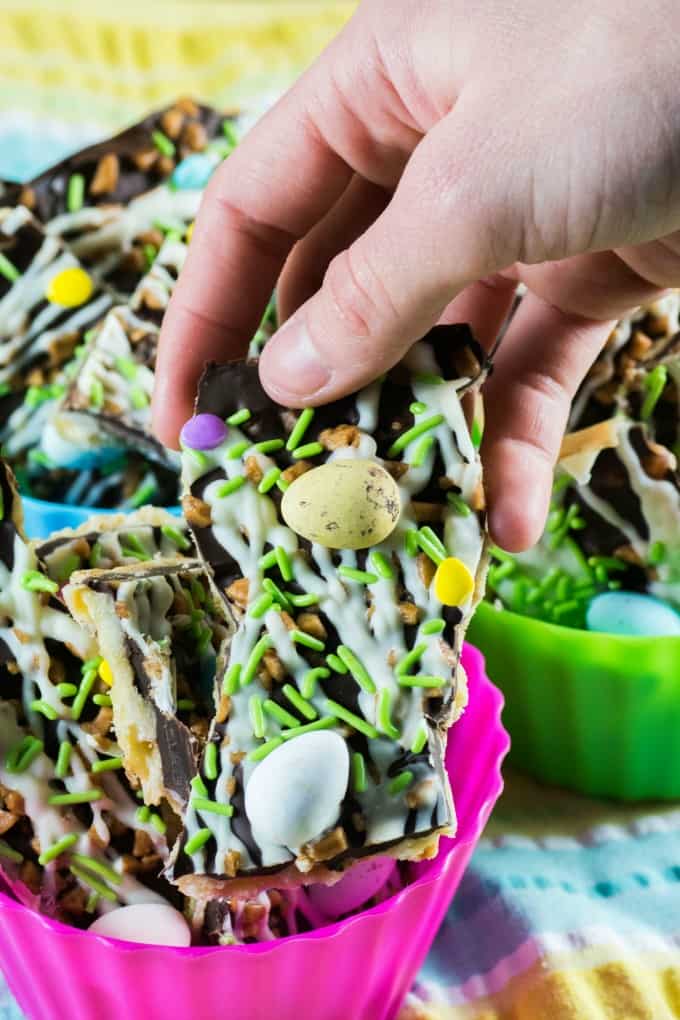 Holding a piece of Easter Toffee Bark