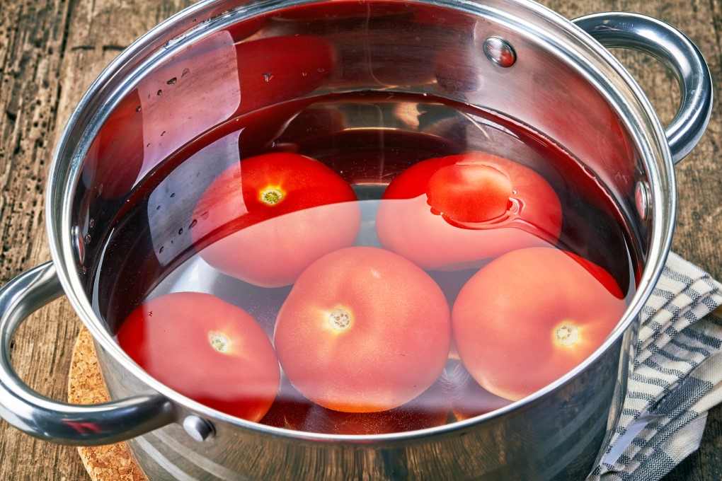 Tomatoes in a pot in water