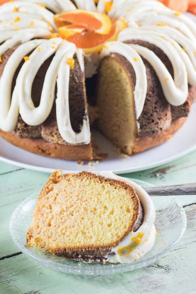 Creamsicle Orange Bundt with one slice on a glass plate