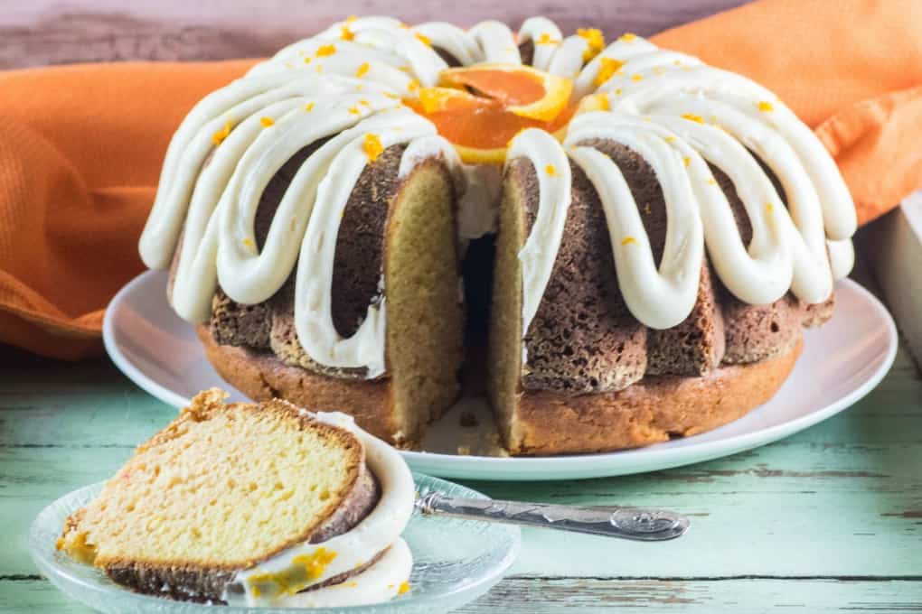 Bundt Cake on a plate with a slice served on a glass plate