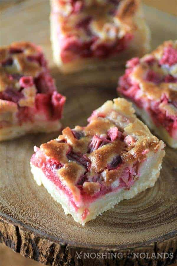 Rhubarb Dream Bars on a wooden tray from 45 Delectable Rhubarb Recipes