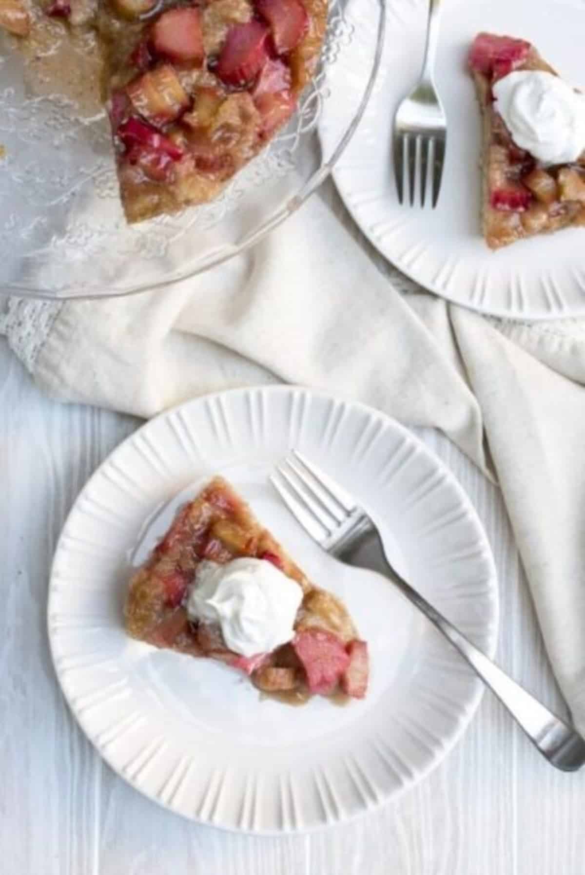 Rhubarb Upside Down Cake on a white plate with fork.