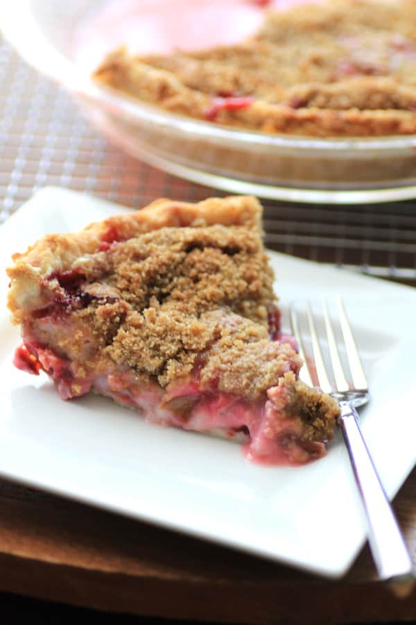 Rhubarb Strawberry Sour Cream Pie served on a white plate from 45 Delectable Rhubarb Recipes