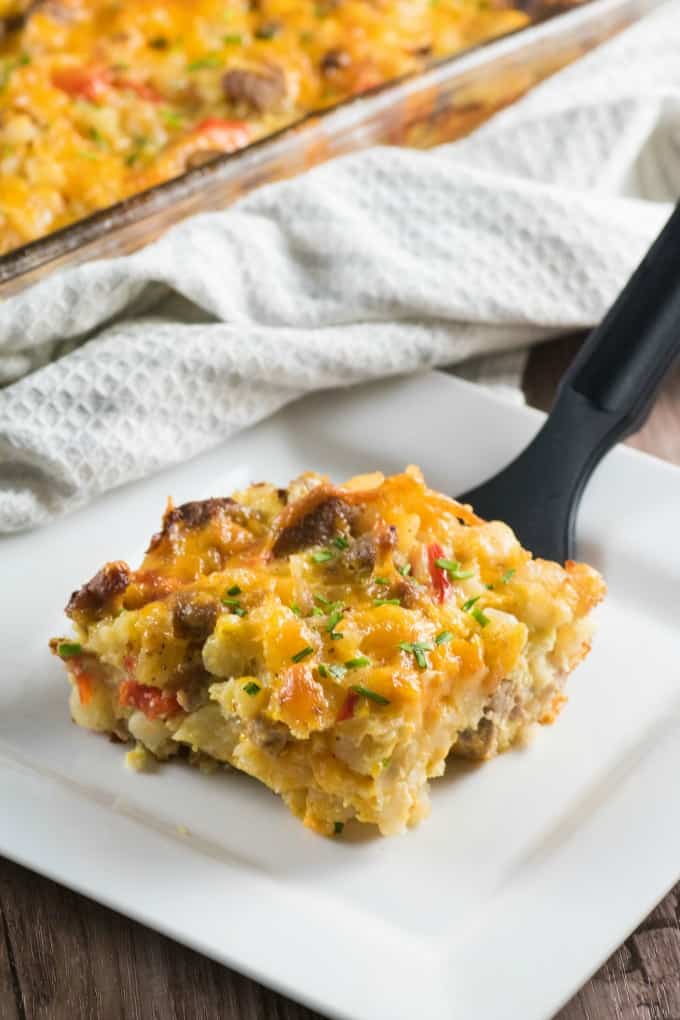 Turkey Sausage Hash Brown Breakfast Casserole being served onto a white plate