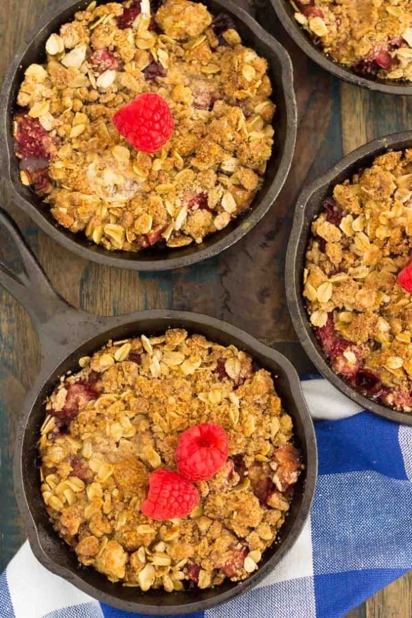 Raspberry Rhubarb Crisp in small cast iron pans from 45 Delectable Rhubarb Recipes