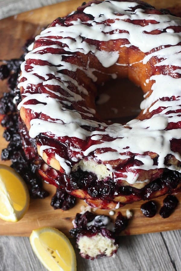 Blueberry Lemon Monkey Bread on a wooden board with fresh lemons