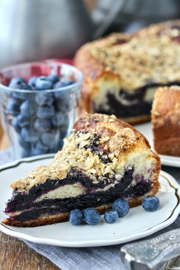 Blueberry Brioche Coffee Cake on a plate with fresh blueberries
