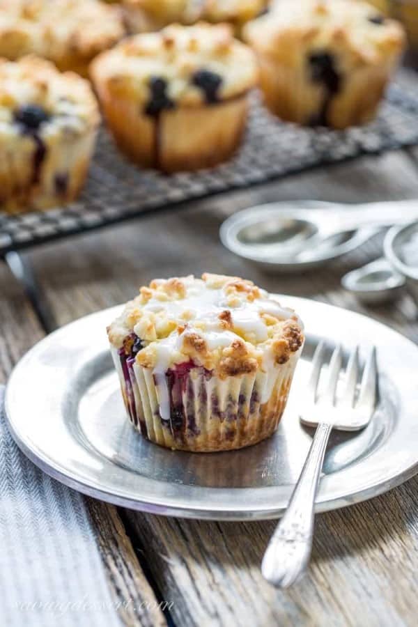 Lemon Blueberry Muffins with Crumble Topping with one on a plate with a fork