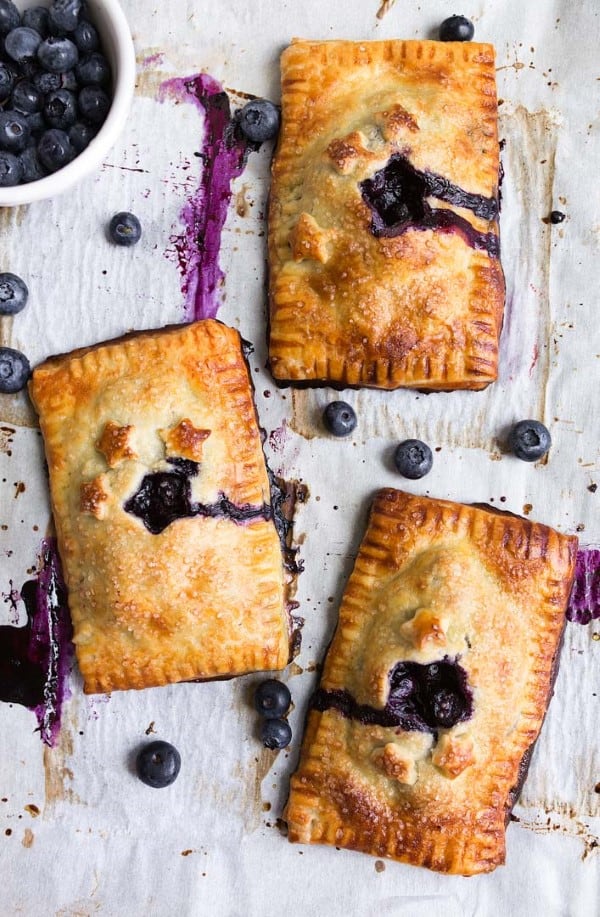 Mini Blueberry Hand Pies on a parchment lined cookie sheet