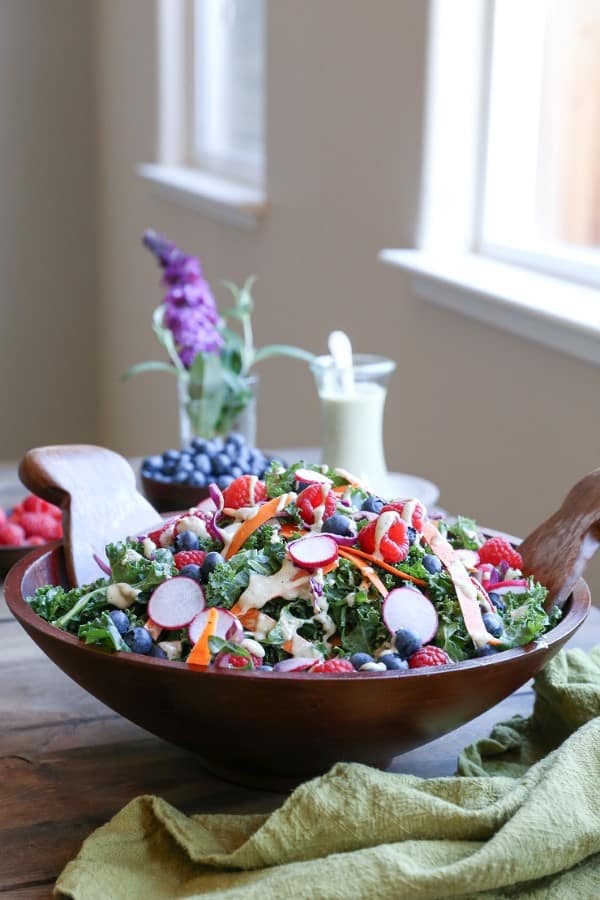 Kale and Blueberry Salad with Vegan Buttermilk Dressing in a wooden bowl on a table