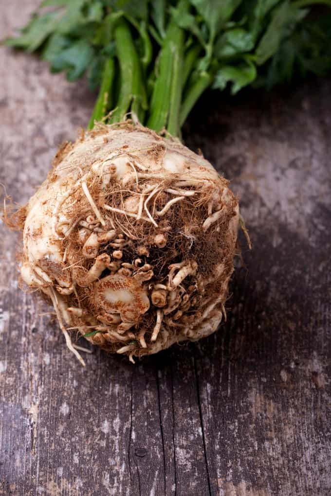 Whole celery root on a rustic board