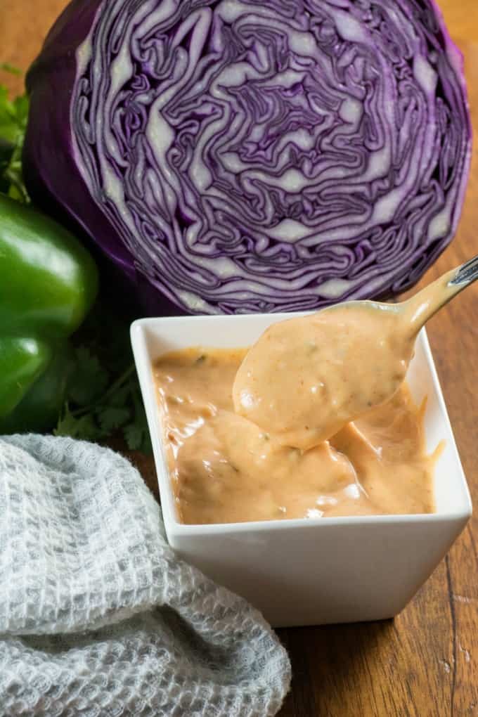 Spooning out Thousand Island Dressing from a small bowl