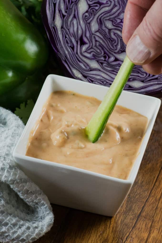 Dipping a cucumber into Thousand Island Dressing