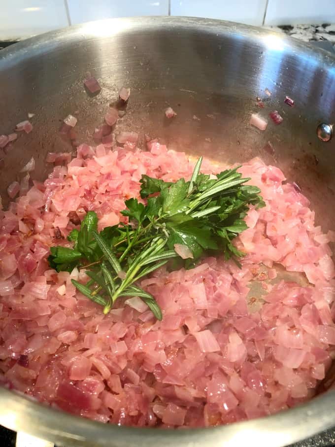 Onion jam with fresh herbs in a pot