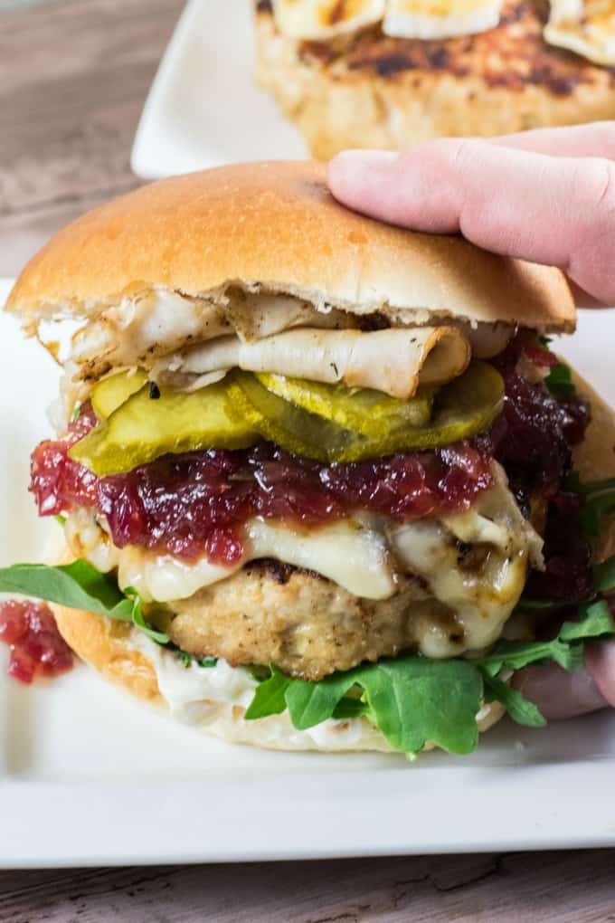 A hand reaching in to grab a Giant Juicy Turkey Burger