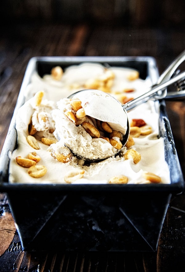 Scoop of coke and salted peanut ice cream form a pan of ice cream