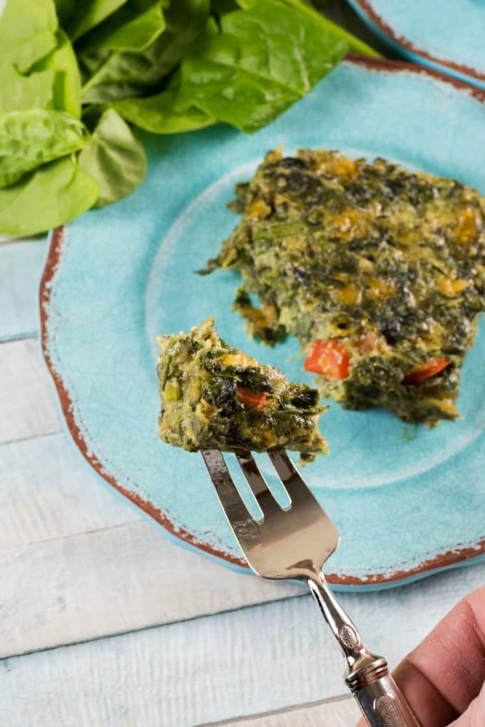 Taking a fork of a delicious spinach square