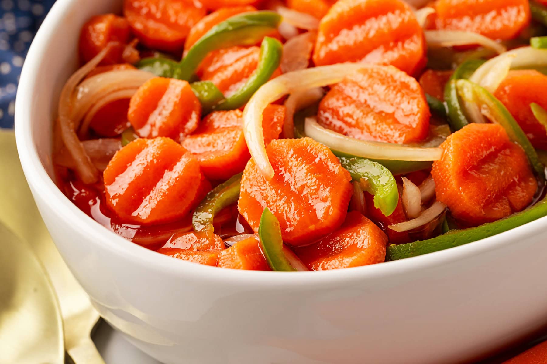 This Marinated Carrot Salad was a staple in our fridge as I grew up. It can be marinated for a long time, so it is perfect to have at the ready for any outing. Horizontal shot of carrot salad.
