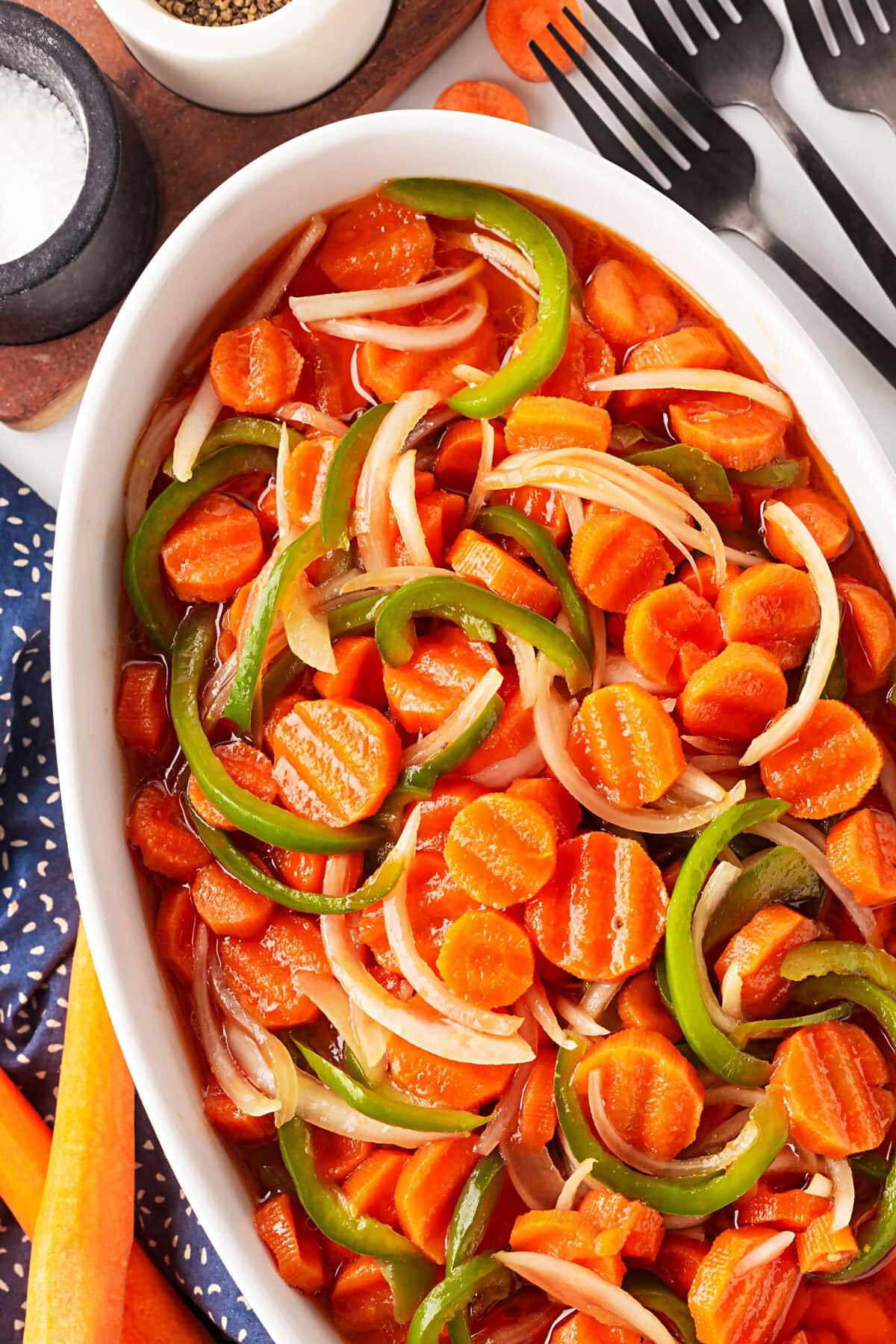 This Marinated Carrot Salad was a staple in our fridge as I grew up. It can be marinated for a long time, so it is perfect to have at the ready for any outing. Overhead of carrot salad.