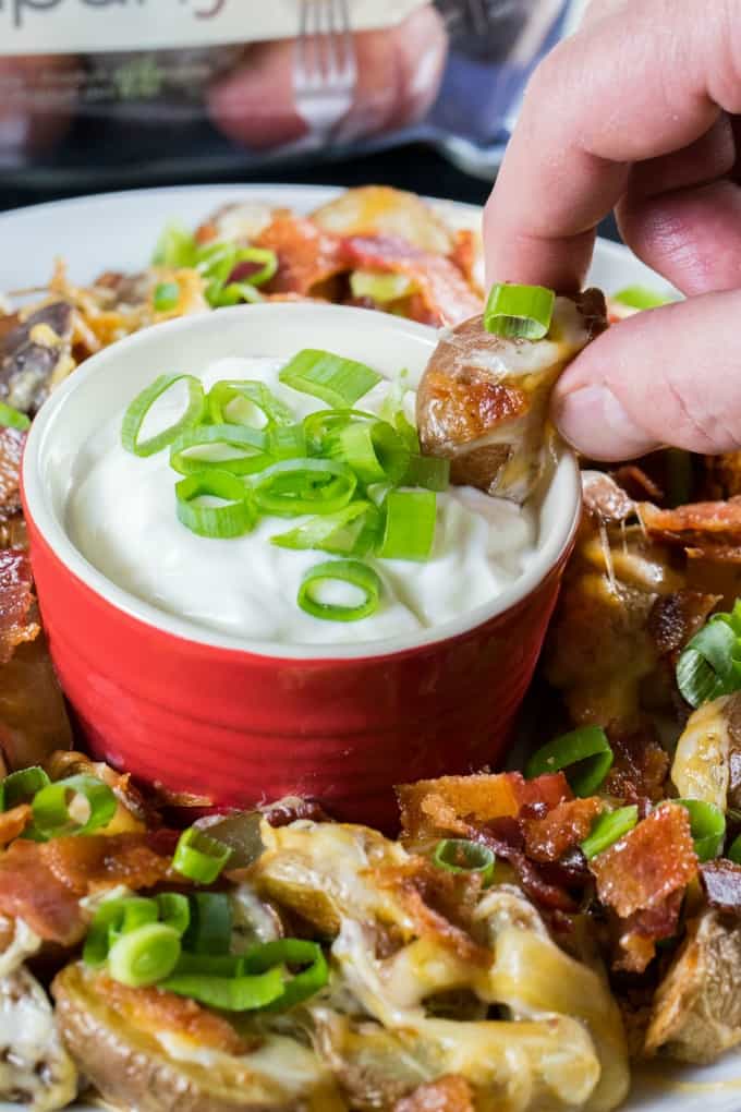 Dipping a potato in sour cream