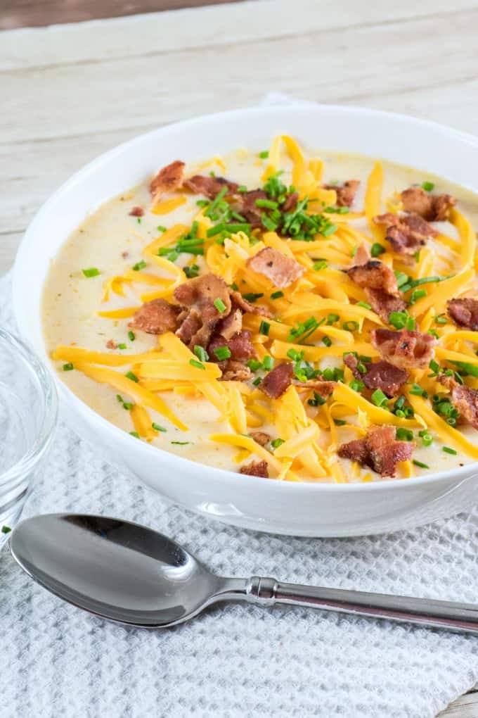 Bowl of Slow Cooker Cauliflower Corn Chowder with a spoon. 