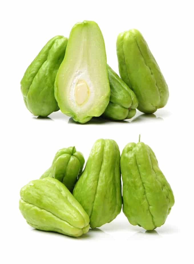 Two pictures of chayote squash, top one with one cup open and bottom on with them standing against each other. 