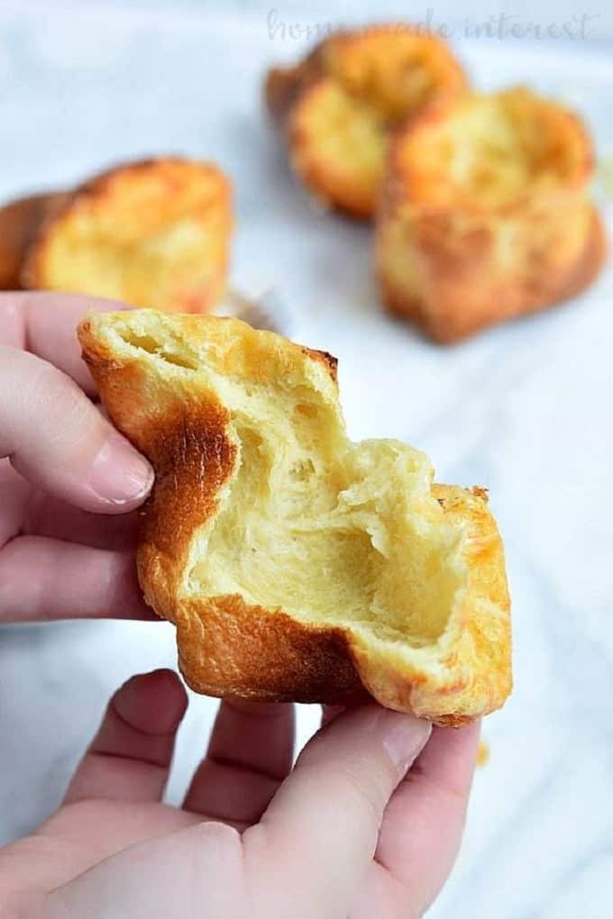 Gruyere Popovers pulled open and held with 2 hands