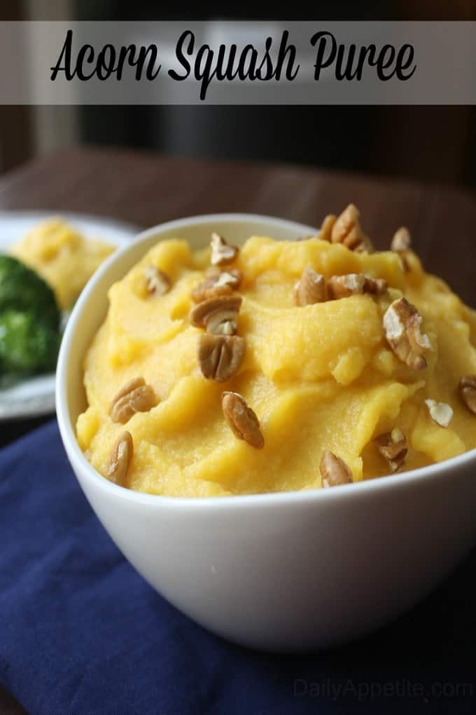Acorn squash puree in a white serving bowl with walnuts on top