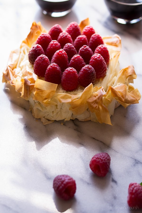 Brie Phyllo Torte With Fresh Raspberries on a marble slab from 18 Easy Hot Party Appetizer Recipes