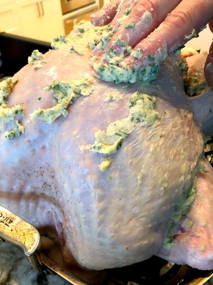 Rubbing herb butter onto a turkey