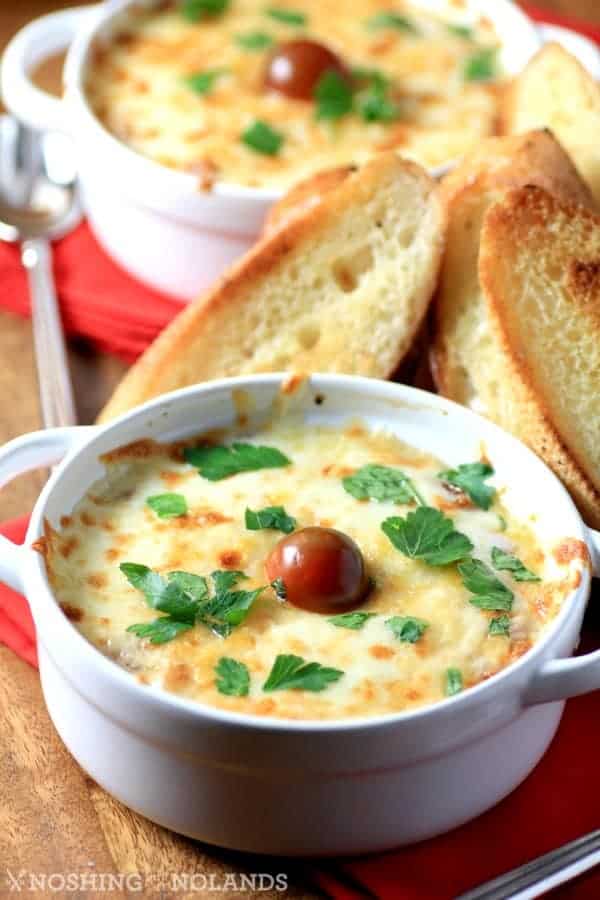 Cheesy Chicken Bruschetta in small white ramekins with crostinis