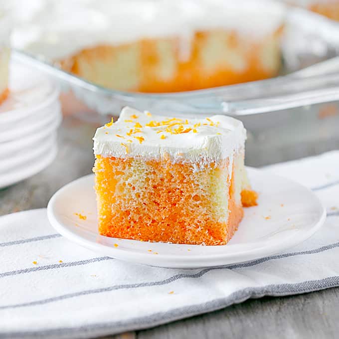 Orange Creamsicle Poke Cake on a white plate