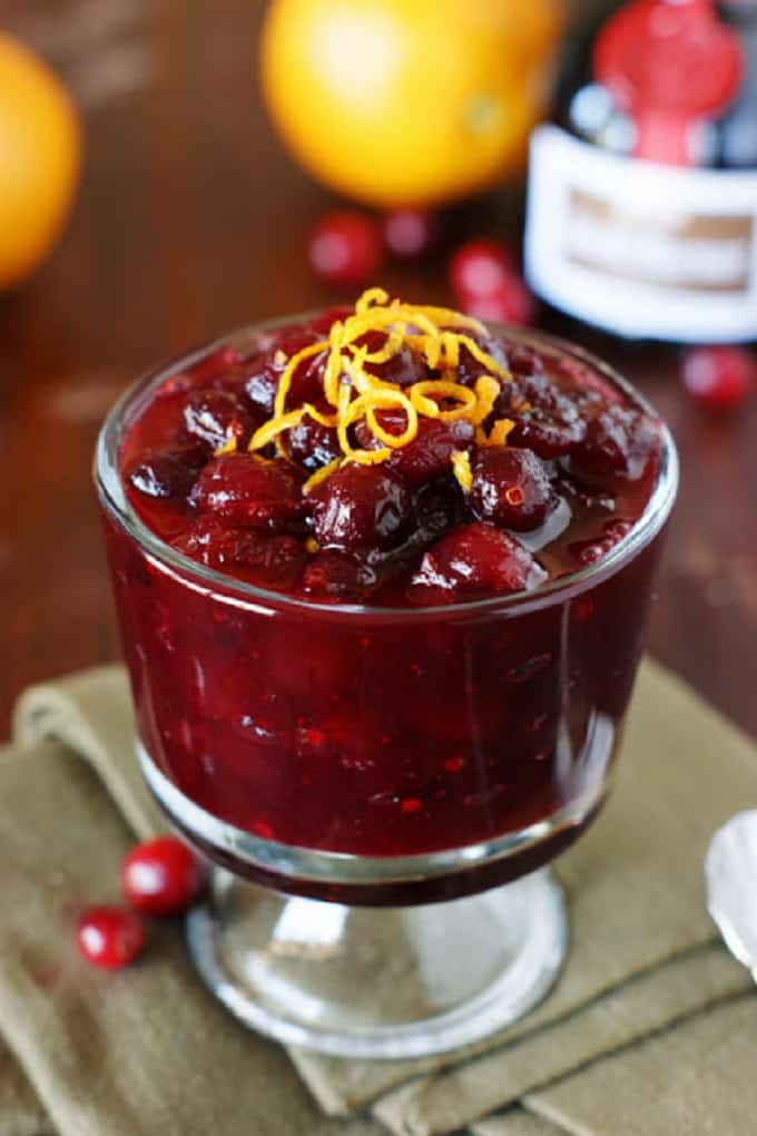 Grand Marnier cranberry sauce in in a glass dish with orange zest on top