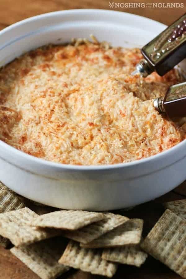 Hot Crab Dip in a white dish with crackers