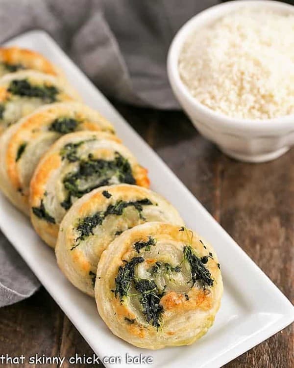Muenster and Spinach Pinwheels on a long white serving dish
