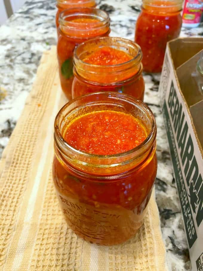 View of open jars of tomato sauce