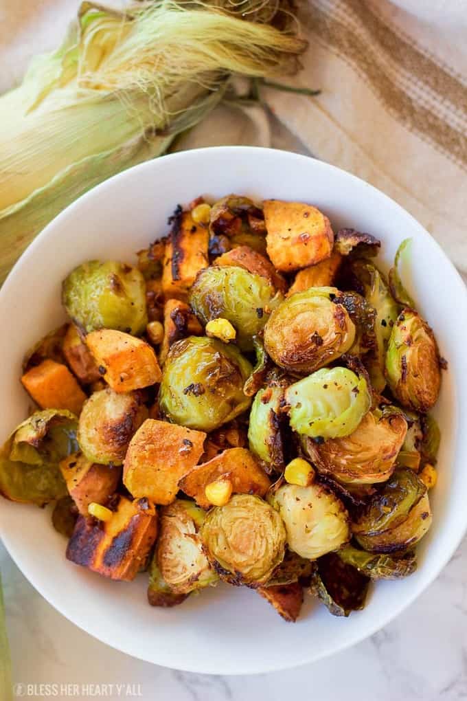 Roasted Brussel Sprouts and sweet potatoes in a white serving bowl