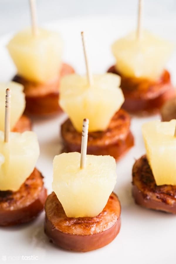 Sausage and Pineapple Bites on a white board