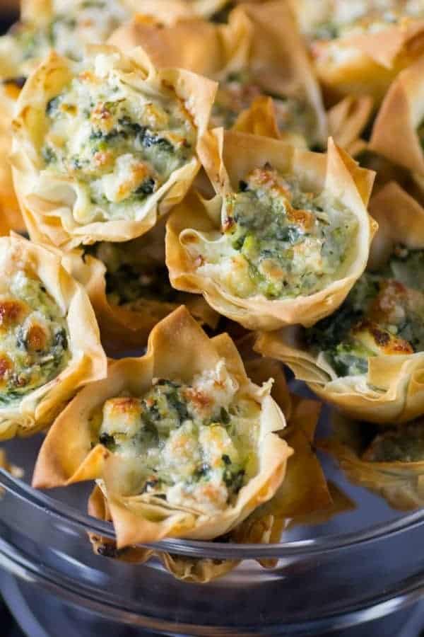 Spanakopita Tarts in a glass serving dish from 18 Easy Hot Party Appetizer Recipes