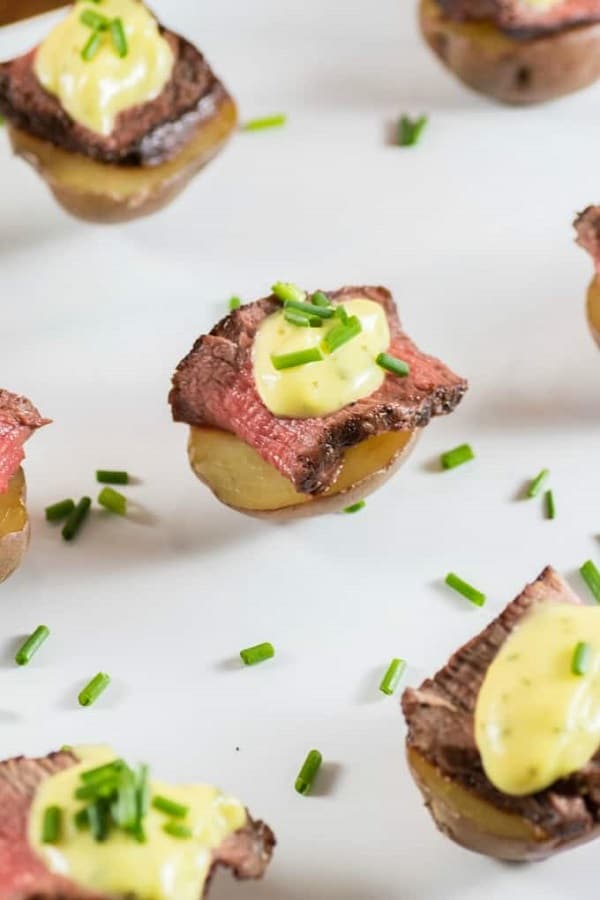 Steak and Potato Appetizers with Bernaise Sauce on top from 18 Easy Hot Party Appetizer Recipes