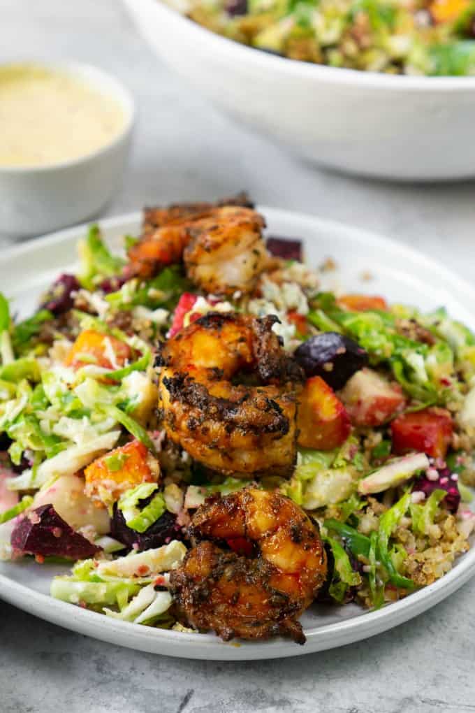 salad with blackened shrimp on a white plate