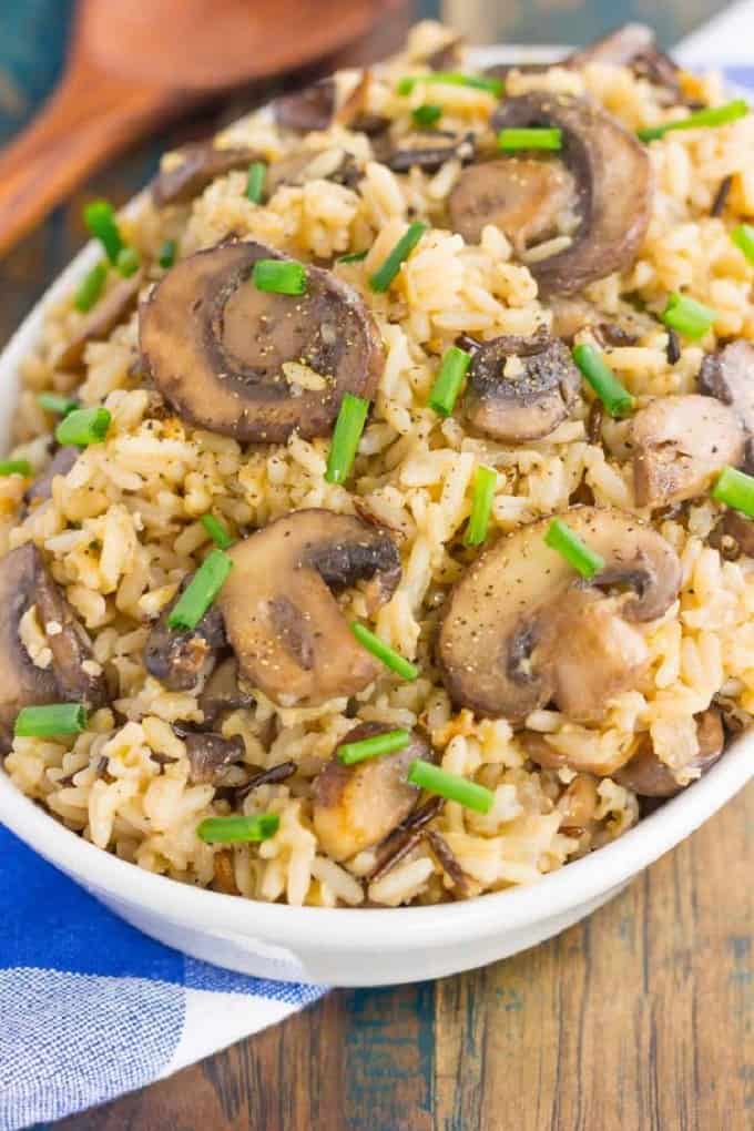 Mushroom wild rice pilaf in a white serving bowl on a wooden table 