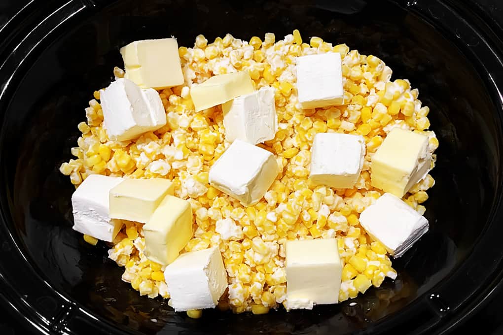 Cubed Butter and Cream Cheese on Corn in Slow Cooker