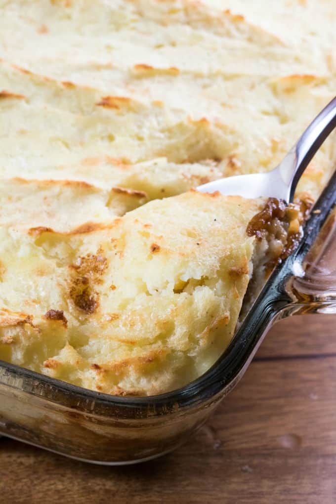 Showing fluffy mashed potatoes coming out of the casserole dish