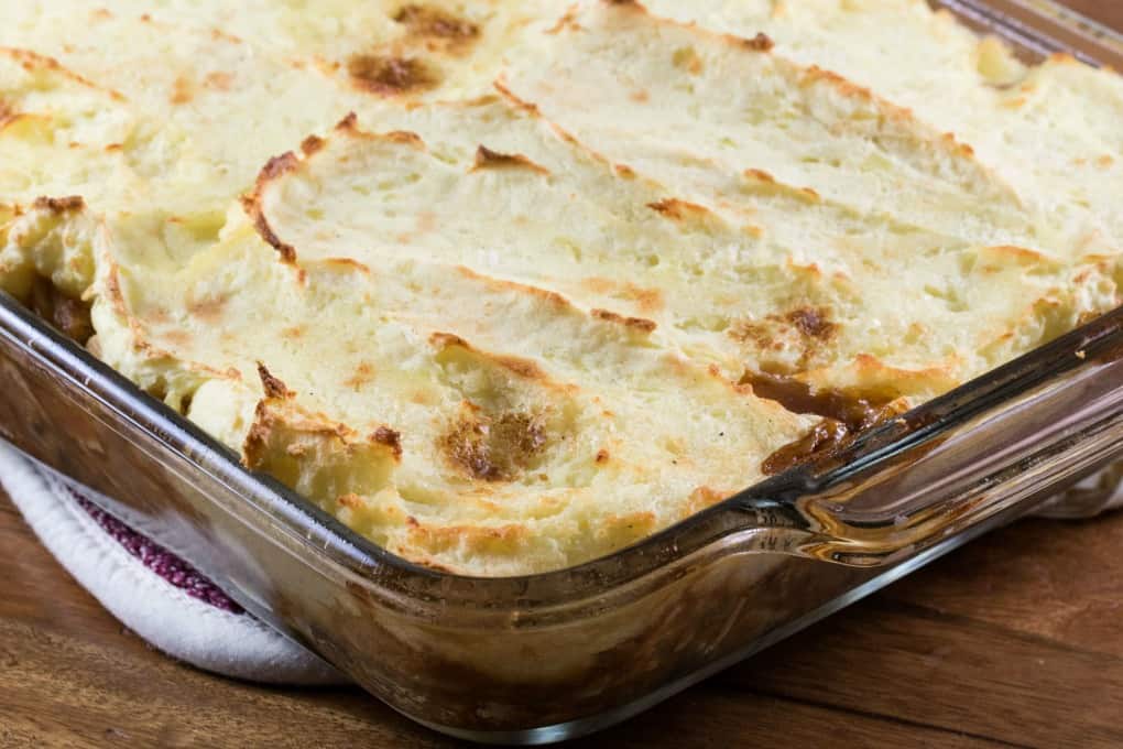 Casserole with a mashed potato topping in a glass baking dish