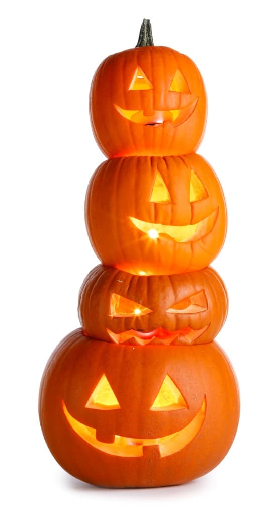 Four pumpkin that are carved in a tier for How to Carve a Pumpkin!